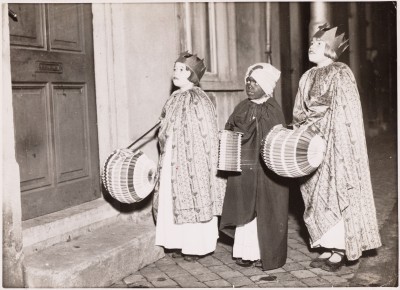 Drie kinderen gaan verkleed als de drie koningen met lampionnen langs de deuren, Tilburg 1934 (foto: Polygoon, collectie Regionaal Archief Tilburg nr. 053094)