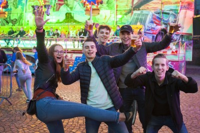 Jongeren op de kermis in corolatijd