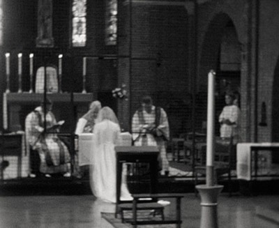 Noviciaat en de inkleding van een postulante, Breda jaren 60 (Filmstill uit de film over de slotzusters van Breda: Erfgoedcentrum Nederlands Kloosterleven, archief Benedictinessen van het H. Sacrament (AR-Z013), filmcollectie AVB-Z013-034)